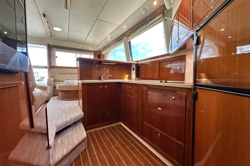 Slide: The Image of Luxurious interior of 2005 Riviera 47 Open Flybridge yacht with elegant wood finishes. - 101