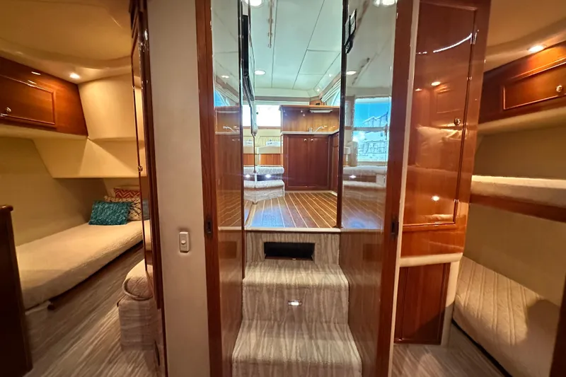 Slide: The Image of Luxurious interior of 2005 Riviera 47 Open Flybridge yacht with wood finishes and cozy seating. - 104