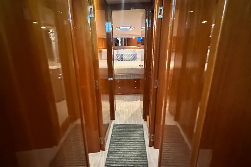 Slide: The Image of Interior hallway of 2005 Riviera 47 Open Flybridge yacht with polished wood finish. - 105