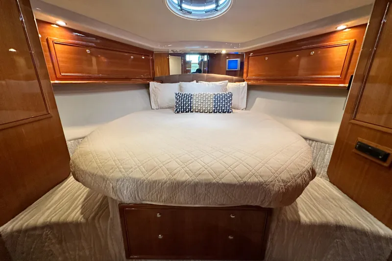 Slide: The Image of Luxurious 2005 Riviera 47 Open Flybridge yacht bedroom with elegant wood cabinetry. - 108