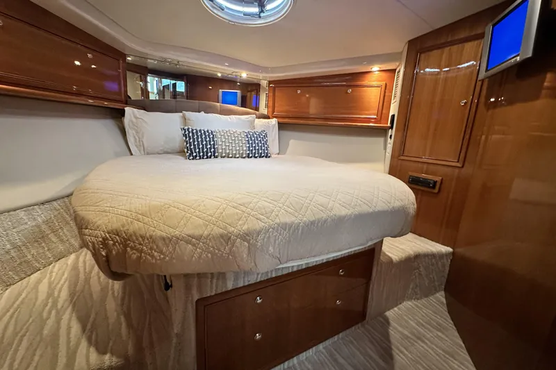 Slide: The Image of Luxurious bedroom interior of 2005 Riviera 47 Open Flybridge yacht with elegant wood finishes. - 109