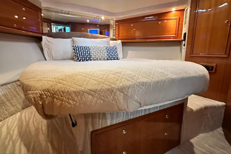 Slide: The Image of Luxurious cabin interior of 2005 Riviera 47 Open Flybridge yacht with cozy bedding. - 110