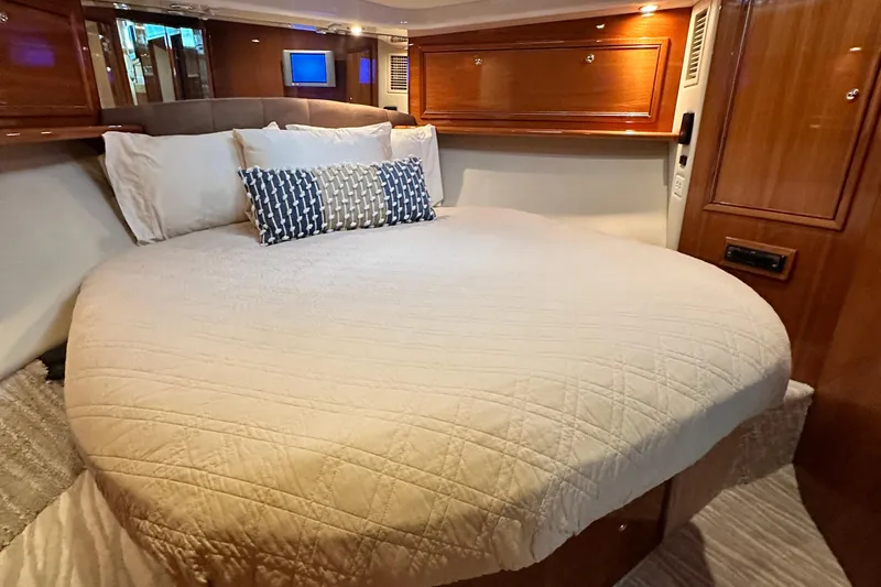 Slide: The Image of Luxurious bedroom interior of 2005 Riviera 47 Open Flybridge yacht. - 111