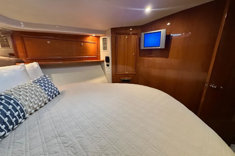 Slide: The Image of Luxurious cabin interior of 2005 Riviera 47 Open Flybridge yacht with cozy bedding. - 113