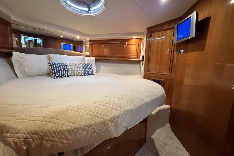 Slide: The Image of Luxurious bedroom interior of 2005 Riviera 47 Open Flybridge yacht with elegant wood finish. - 117