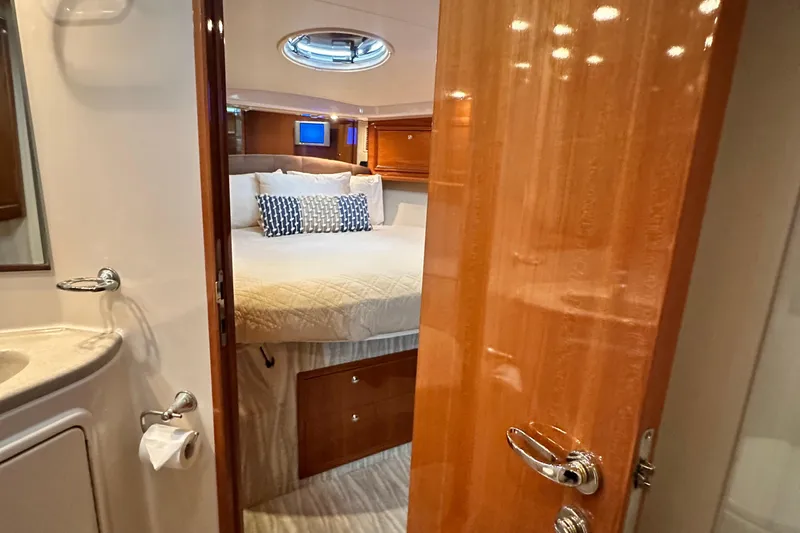 Slide: The Image of Luxurious bedroom interior of 2005 Riviera 47 Open Flybridge yacht. - 118