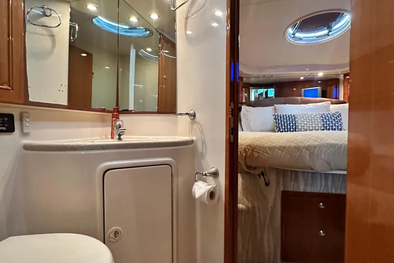 Slide: The Image of Luxurious 2005 Riviera 47 Open Flybridge yacht interior with bathroom and cozy bedroom. - 119