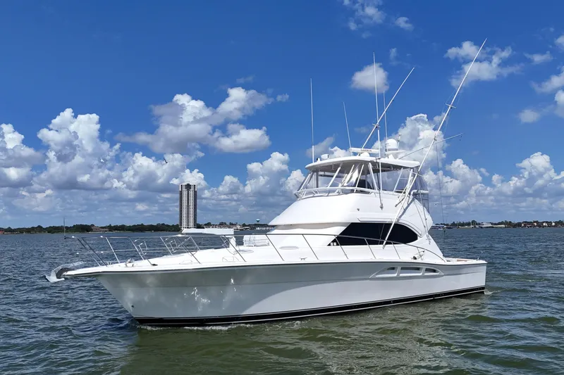 Slide: The Image of 2005 Riviera 47 Open Flybridge yacht on water under blue sky. - 12