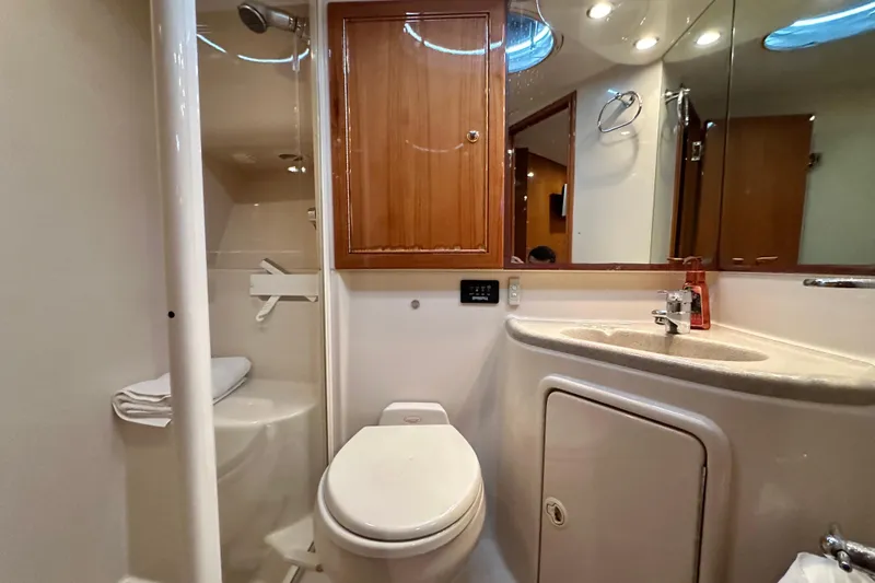 Slide: The Image of Luxurious bathroom in 2005 Riviera 47 Open Flybridge yacht, featuring modern fixtures and wood accents. - 120