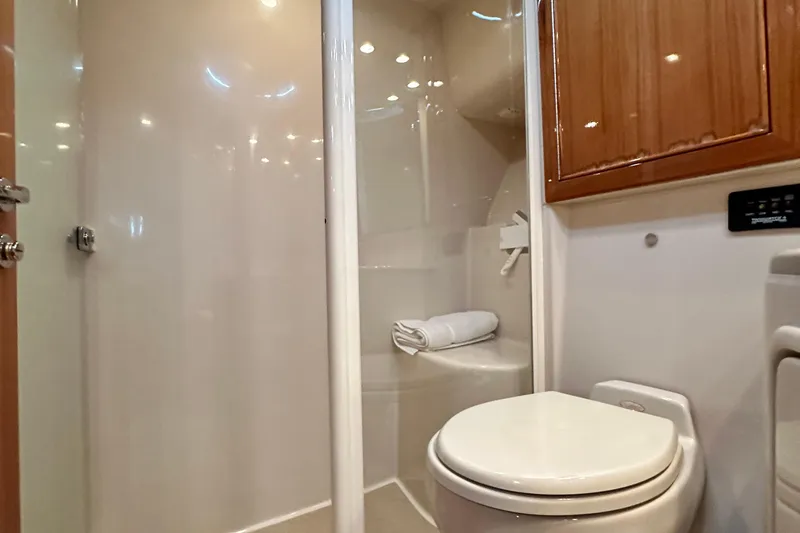 Slide: The Image of 2005 Riviera 47 Open Flybridge yacht bathroom with shower and toilet. - 124