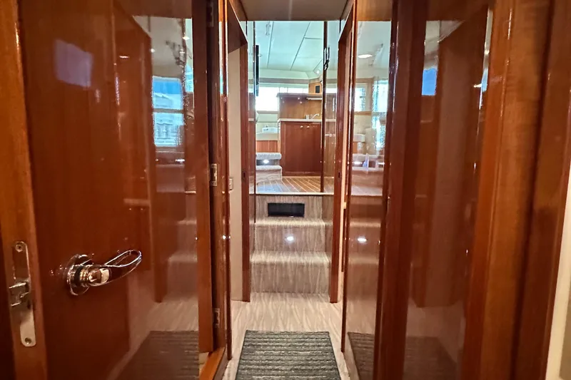 Slide: The Image of Interior hallway of 2005 Riviera 47 Open Flybridge yacht with polished wood finish. - 126