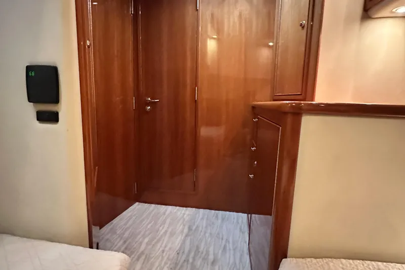 Slide: The Image of Interior of 2005 Riviera 47 Open Flybridge with polished wood finish and modern lighting. - 137