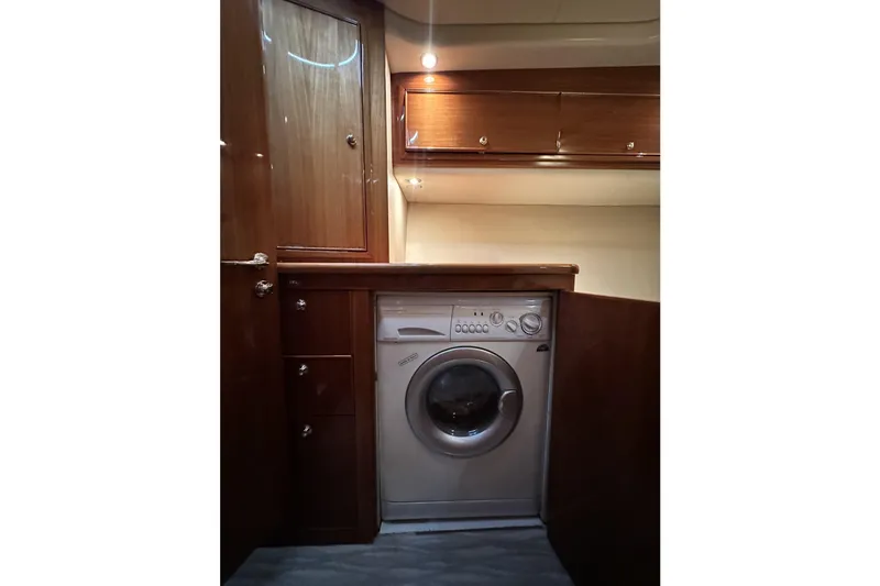 Slide: The Image of Laundry area in 2005 Riviera 47 Open Flybridge yacht with wood cabinetry. - 138