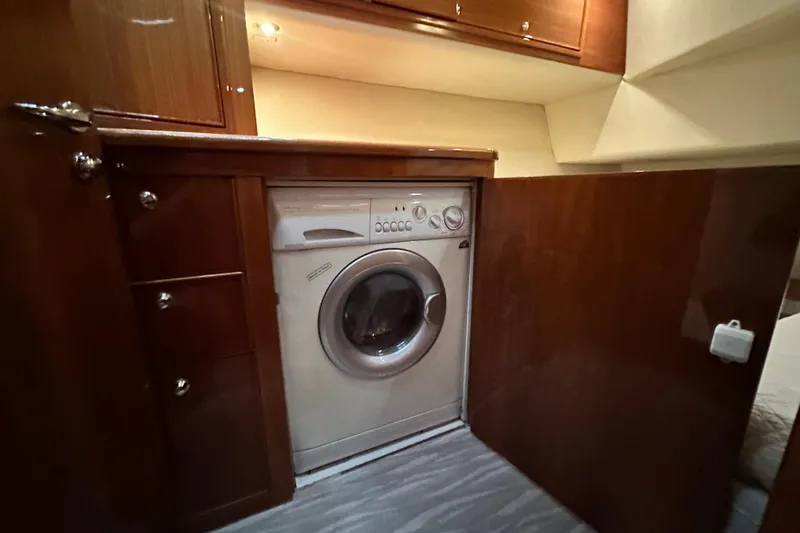 Slide: The Image of Laundry area with washing machine in 2005 Riviera 47 Open Flybridge yacht. - 139