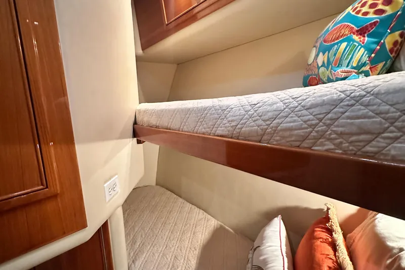 Slide: The Image of Interior of 2005 Riviera 47 Open Flybridge with cozy bunk beds and colorful pillows. - 144