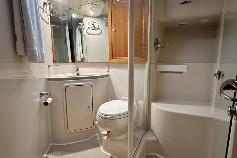 Slide: The Image of Bathroom interior of 2005 Riviera 47 Open Flybridge yacht, featuring sink, toilet, and shower. - 145