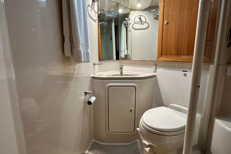 Slide: The Image of Bathroom interior of 2005 Riviera 47 Open Flybridge yacht, featuring sink and toilet. - 148