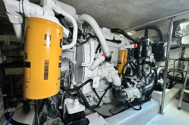 Slide: The Image of Engine room of 2005 Riviera 47 Open Flybridge with visible components and filters. - 154