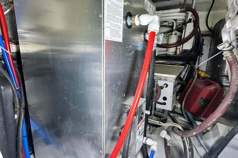 Slide: The Image of Engine room of 2005 Riviera 47 Open Flybridge with visible pipes and machinery. - 159