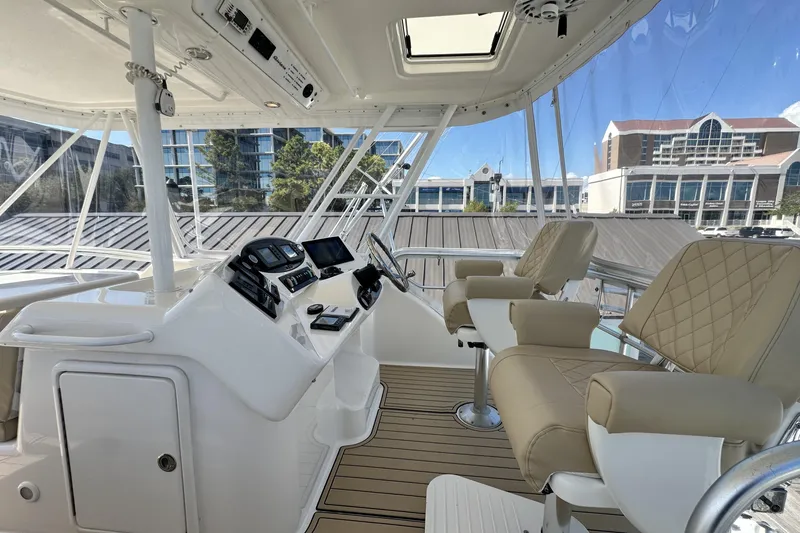 Slide: The Image of 2005 Riviera 47 Open Flybridge interior with modern helm and luxurious seating. - 21