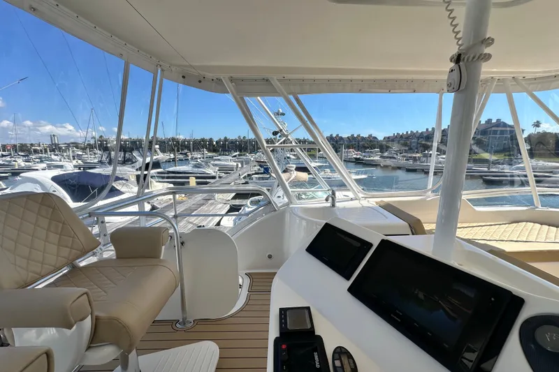 Slide: The Image of 2005 Riviera 47 Open Flybridge yacht interior with marina view, featuring modern navigation equipment. - 27