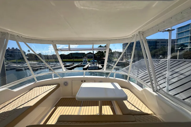 Slide: The Image of 2005 Riviera 47 Open Flybridge interior with marina view through large windows. - 32