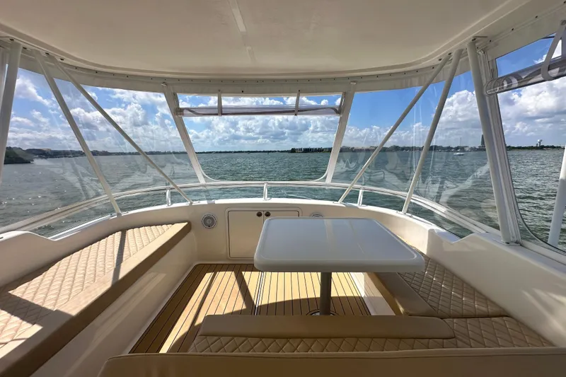 Slide: The Image of 2005 Riviera 47 Open Flybridge interior with panoramic water view and elegant seating. - 33