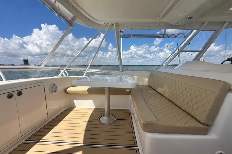 Slide: The Image of 2005 Riviera 47 Open Flybridge interior with beige seating and ocean view. - 35