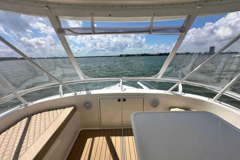 Slide: The Image of 2005 Riviera 47 Open Flybridge interior with ocean view, featuring seating and table. - 37