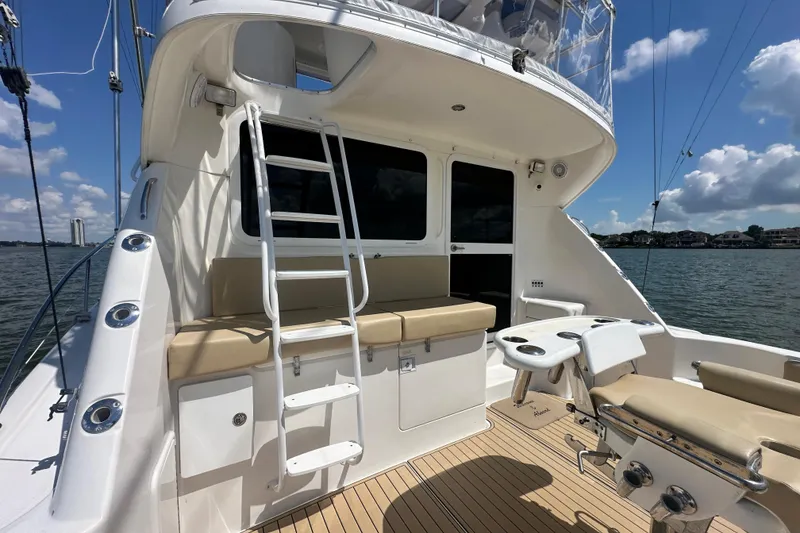 Slide: The Image of 2005 Riviera 47 Open Flybridge yacht with seating, ladder, and ocean view. - 41