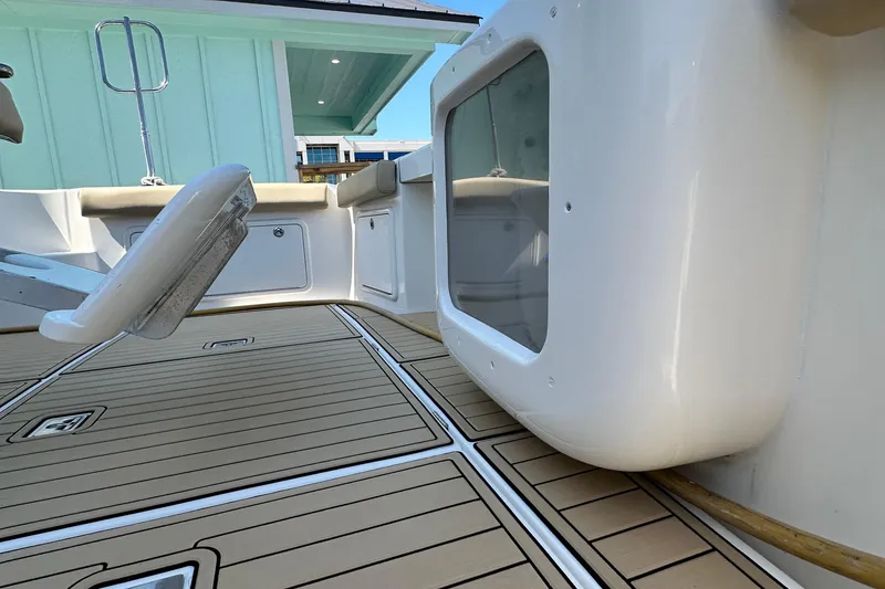 Slide: The Image of 2005 Riviera 47 Open Flybridge yacht deck with seating and storage compartments. - 49