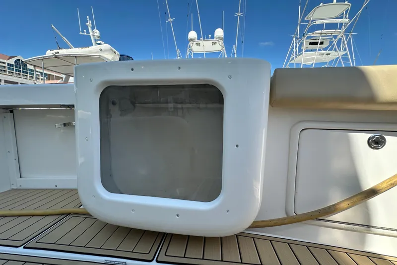 Slide: The Image of 2005 Riviera 47 Open Flybridge deck with storage compartment and teak flooring. - 50