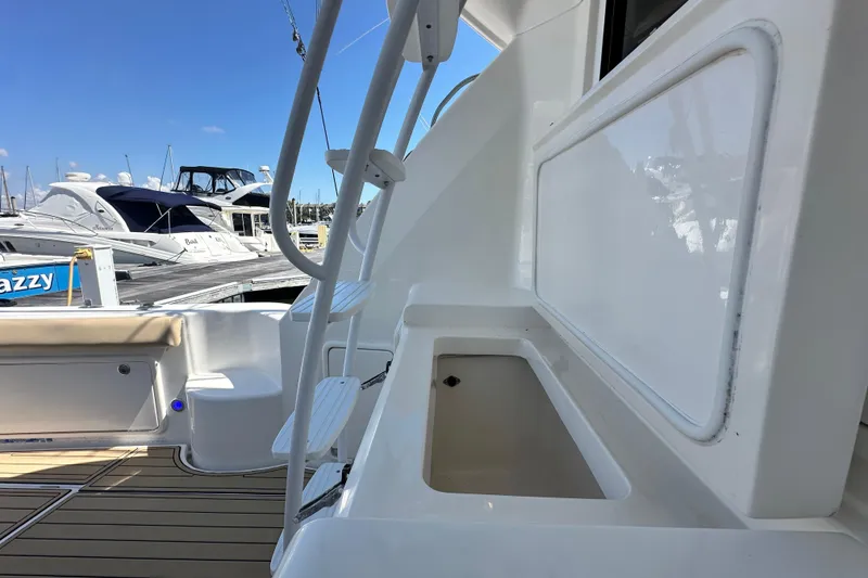 Slide: The Image of 2005 Riviera 47 Open Flybridge yacht interior with docked boats in background. - 52