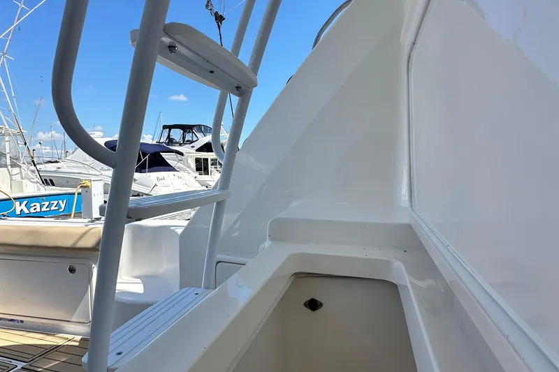 Slide: The Image of 2005 Riviera 47 Open Flybridge yacht detail with marina background. - 53