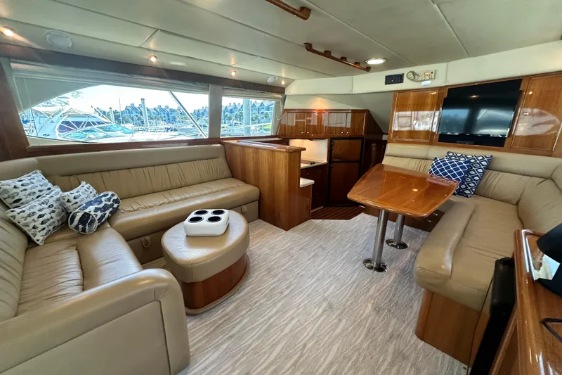 Slide: The Image of Luxurious interior of 2005 Riviera 47 Open Flybridge yacht with plush seating and elegant wood finishes. - 55