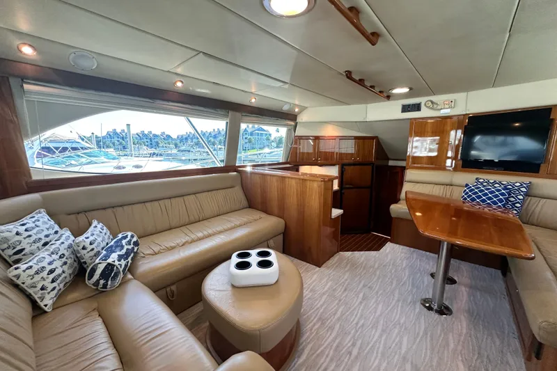 Slide: The Image of Luxurious interior of 2005 Riviera 47 Open Flybridge yacht with plush seating and elegant wood finishes. - 56