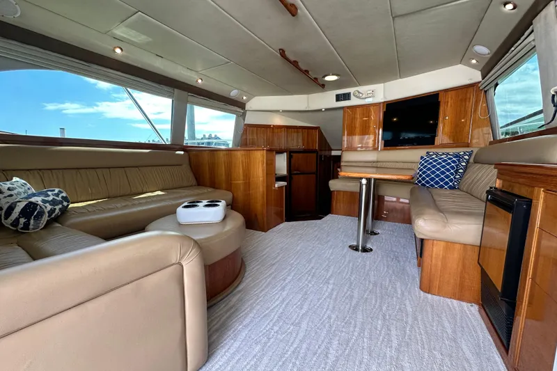 Slide: The Image of Luxurious interior of 2005 Riviera 47 Open Flybridge yacht with leather seating and wood finishes. - 57