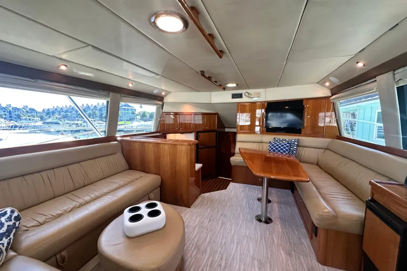 Slide: The Image of Luxurious interior of 2005 Riviera 47 Open Flybridge yacht with elegant seating and wood finishes. - 59