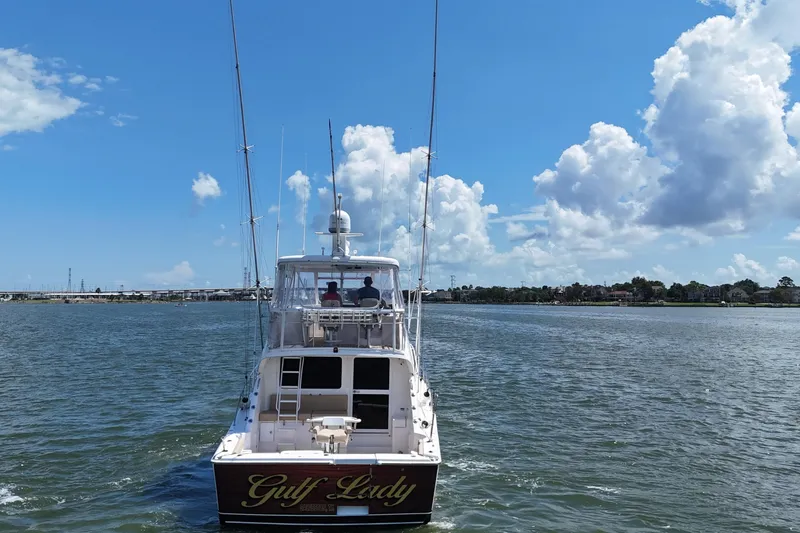 Slide: The Image of 2005 Riviera 47 Open Flybridge yacht on water under blue sky with clouds. - 6