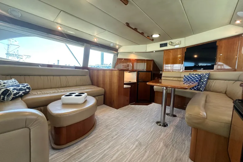 Slide: The Image of Luxurious interior of 2005 Riviera 47 Open Flybridge yacht with plush seating and elegant decor. - 60