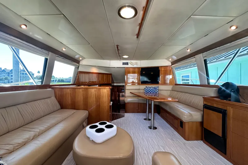 Slide: The Image of Luxurious interior of 2005 Riviera 47 Open Flybridge yacht with leather seating and wood finishes. - 61