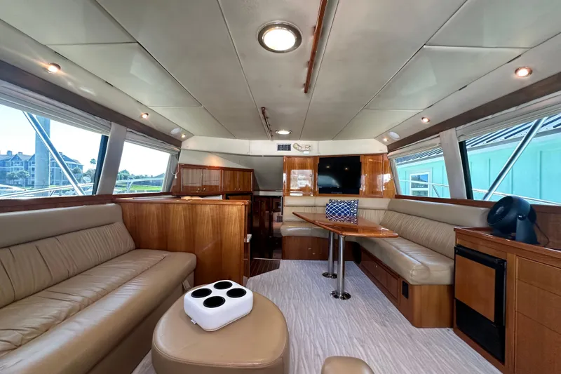 Slide: The Image of Luxurious interior of 2005 Riviera 47 Open Flybridge yacht with leather seating and wooden finishes. - 64