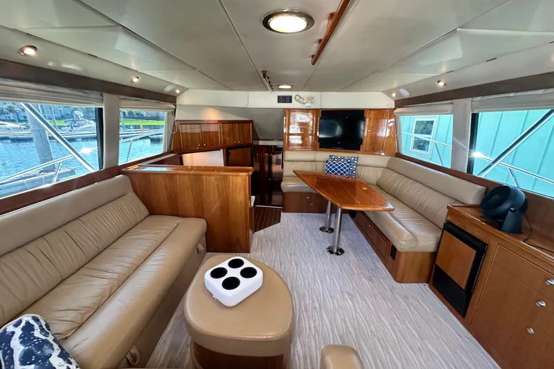 Slide: The Image of Luxurious interior of 2005 Riviera 47 Open Flybridge yacht with elegant seating and wooden finishes. - 66