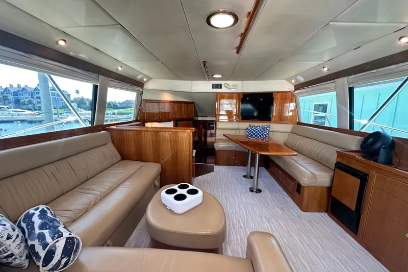 Slide: The Image of Luxurious interior of 2005 Riviera 47 Open Flybridge yacht with leather seating and wooden accents. - 68