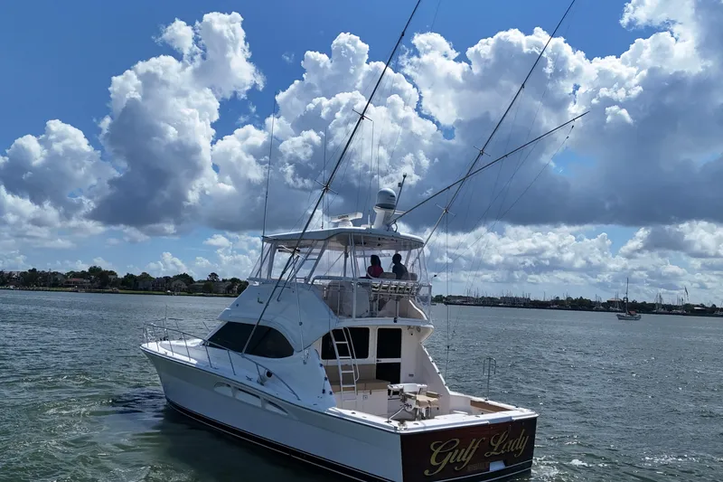 Slide: The Image of 2005 Riviera 47 Open Flybridge yacht cruising under a cloudy sky. - 7