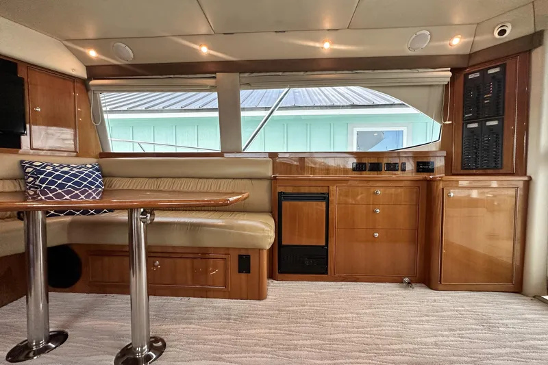 Slide: The Image of Interior of 2005 Riviera 47 Open Flybridge yacht with wood cabinetry and seating area. - 74