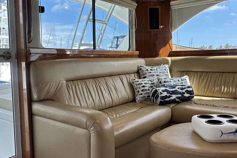Slide: The Image of Luxurious interior of 2005 Riviera 47 Open Flybridge with leather seating and nautical-themed pillows. - 76