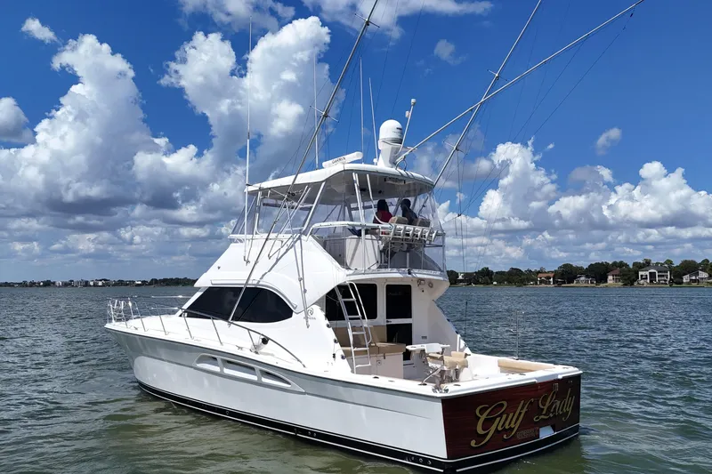 Slide: The Image of 2005 Riviera 47 Open Flybridge yacht on water under blue sky with clouds. - 8