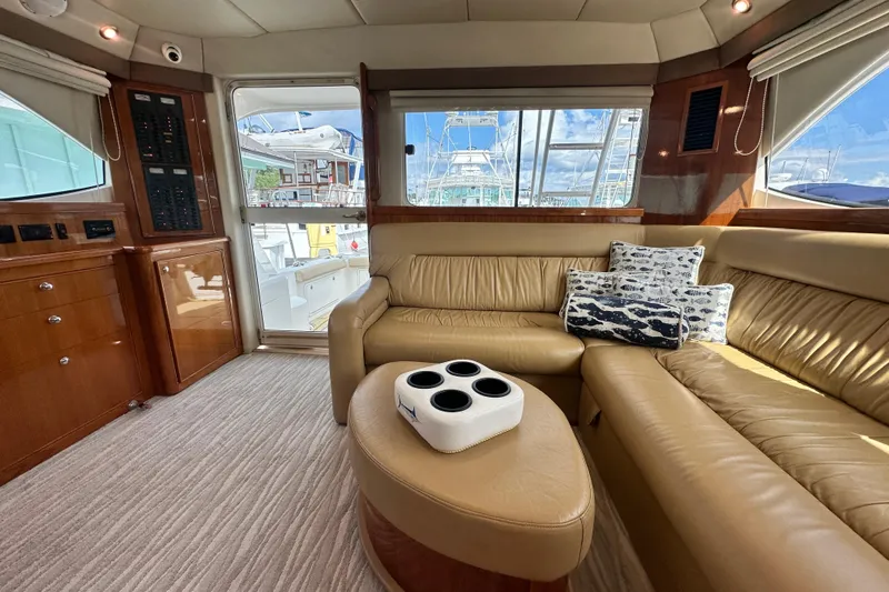 Slide: The Image of Luxurious interior of 2005 Riviera 47 Open Flybridge yacht with leather seating and nautical decor. - 80