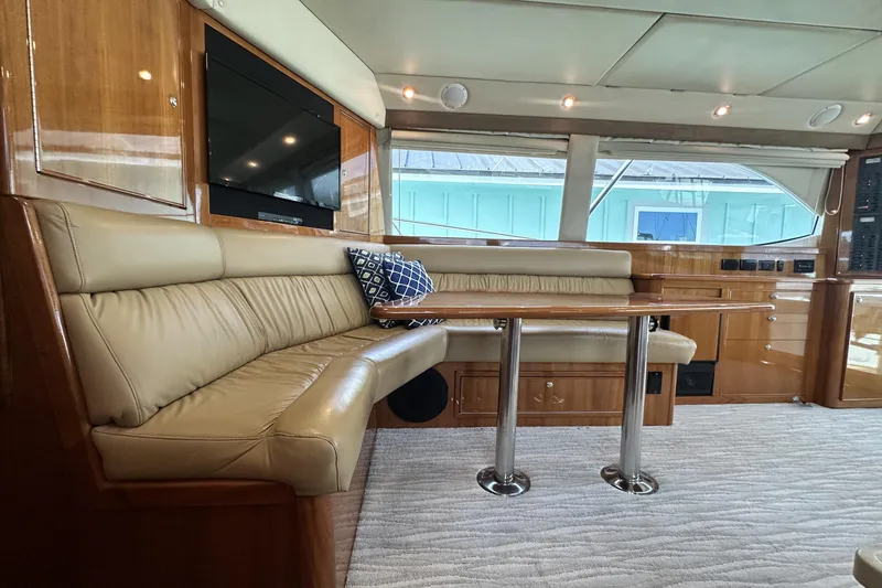 Slide: The Image of Luxurious interior of 2005 Riviera 47 Open Flybridge yacht with leather seating and wooden table. - 81